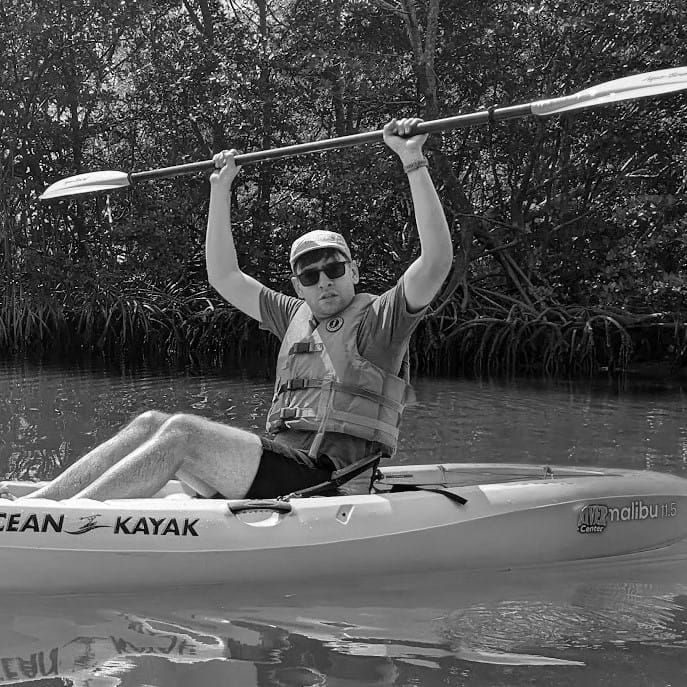 AJ on a kayak in a black and white photo